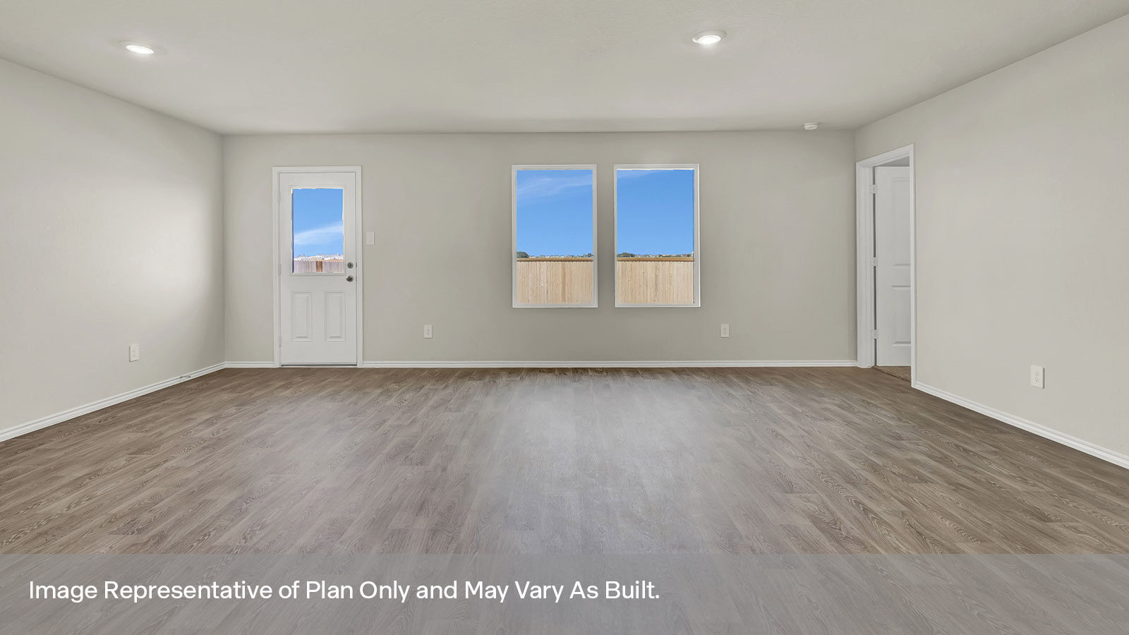 Living room and dining room with vinyl flooring, two windows, and a half lite exterior door.