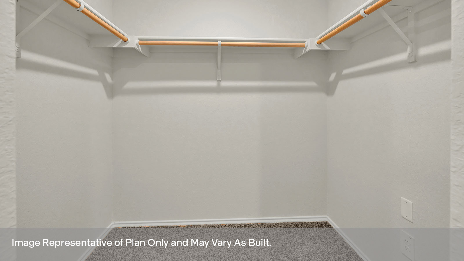 Main bedroom walk-in closet with carpeting and wooden shelving.