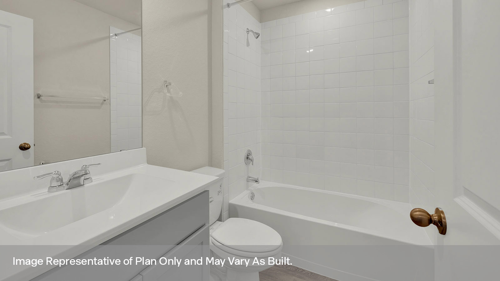 Hall bathroom with vanity, toilet, and tub with tile surround.