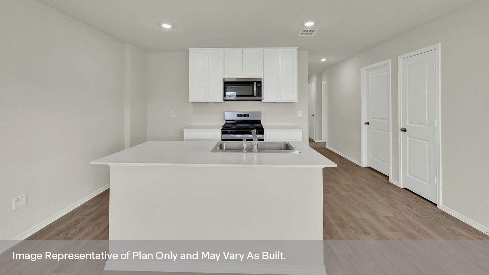Kitchen with kitchen island and white cabinets.