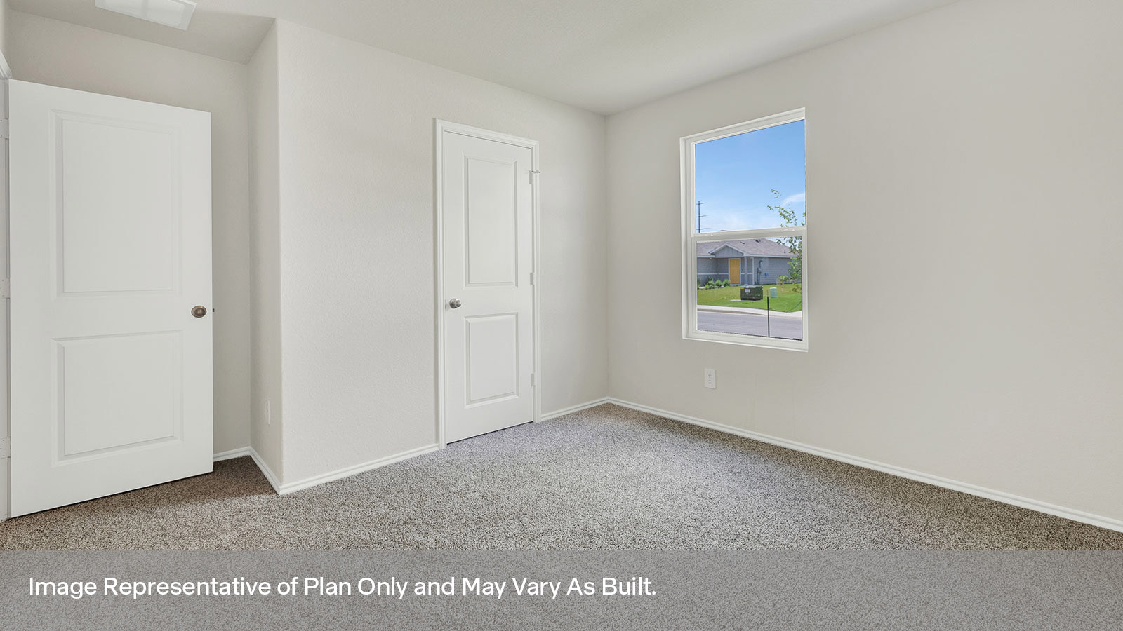 Front bedroom with carpeting and one window.
