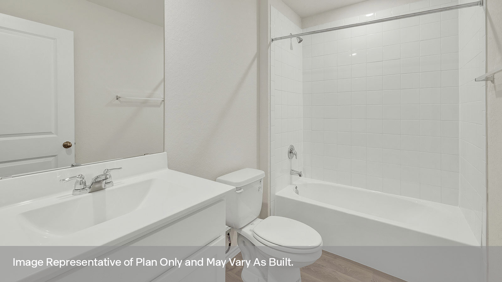 Hall bathroom with vanity, toilet, and tub with tile surround.