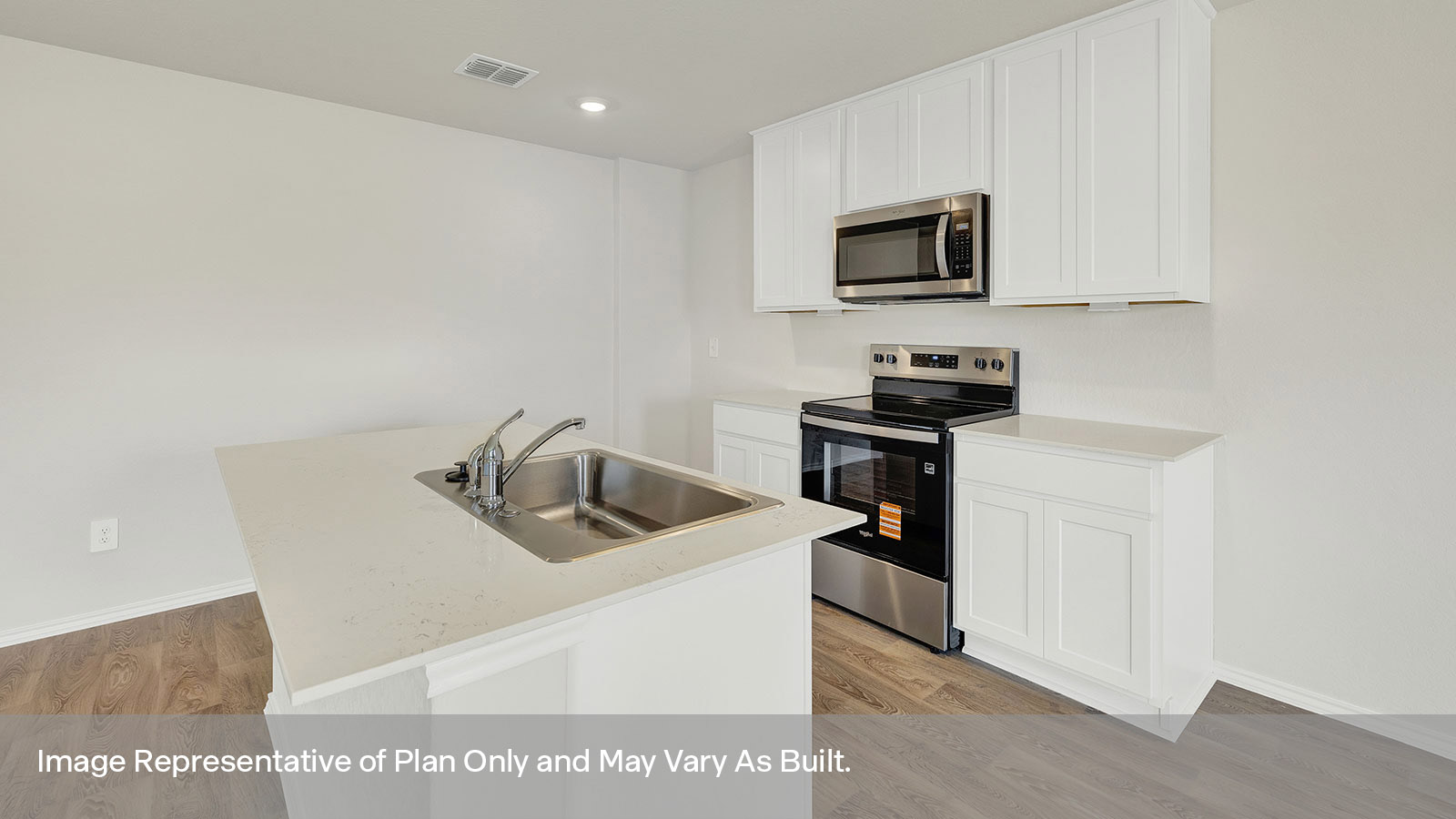 Kitchen with quartz countertops and stainless steel appliances.