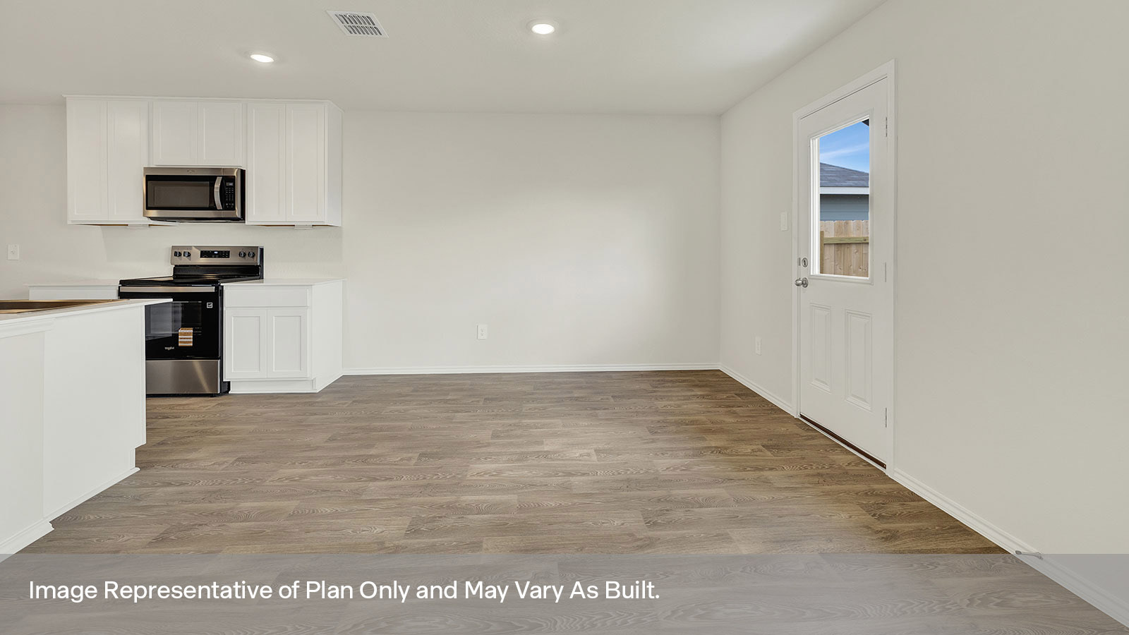 Dining room with vinyl flooring and a half lite exterior door.