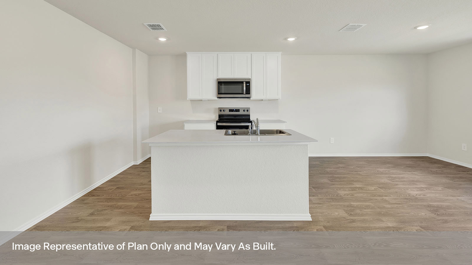 Kitchen with kitchen island and white cabinets.