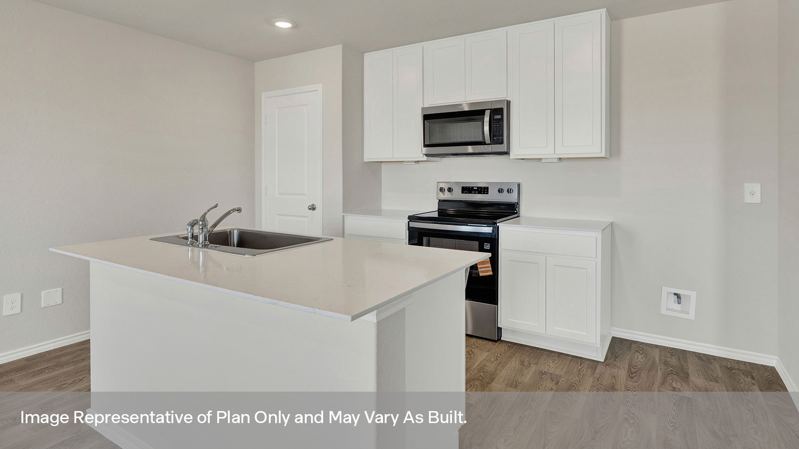 Kitchen with kitchen island and white cabinets.