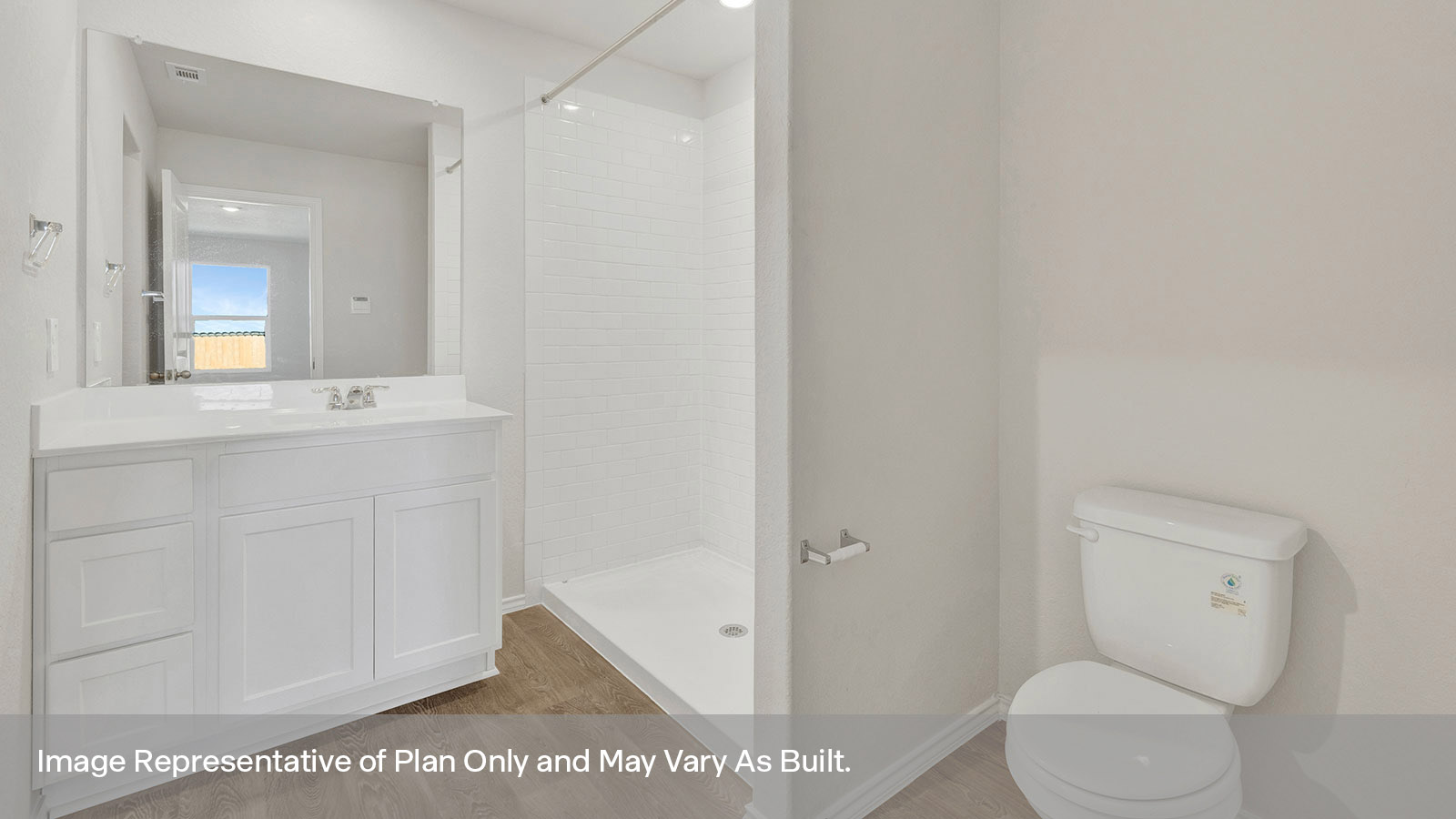 Main bathroom with toilet, vanity, and shower.