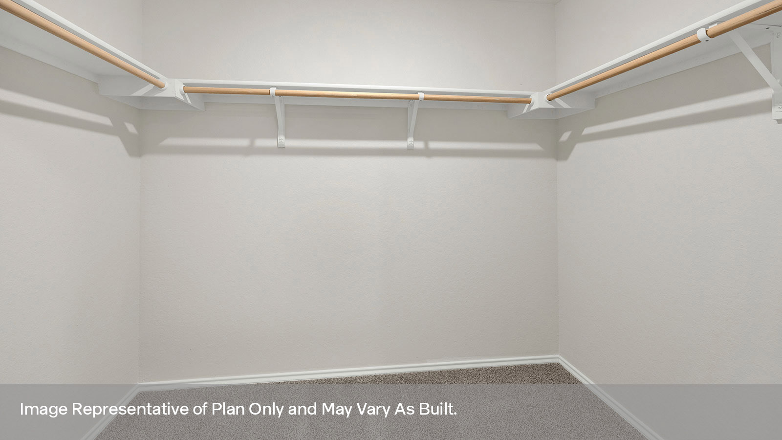 Main bedroom closet with carpeting and wooden shelving.