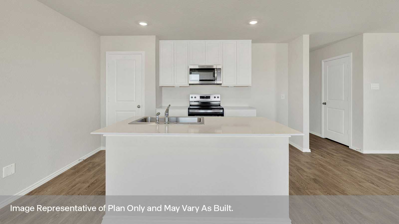 Kitchen with kitchen island and white cabinets.