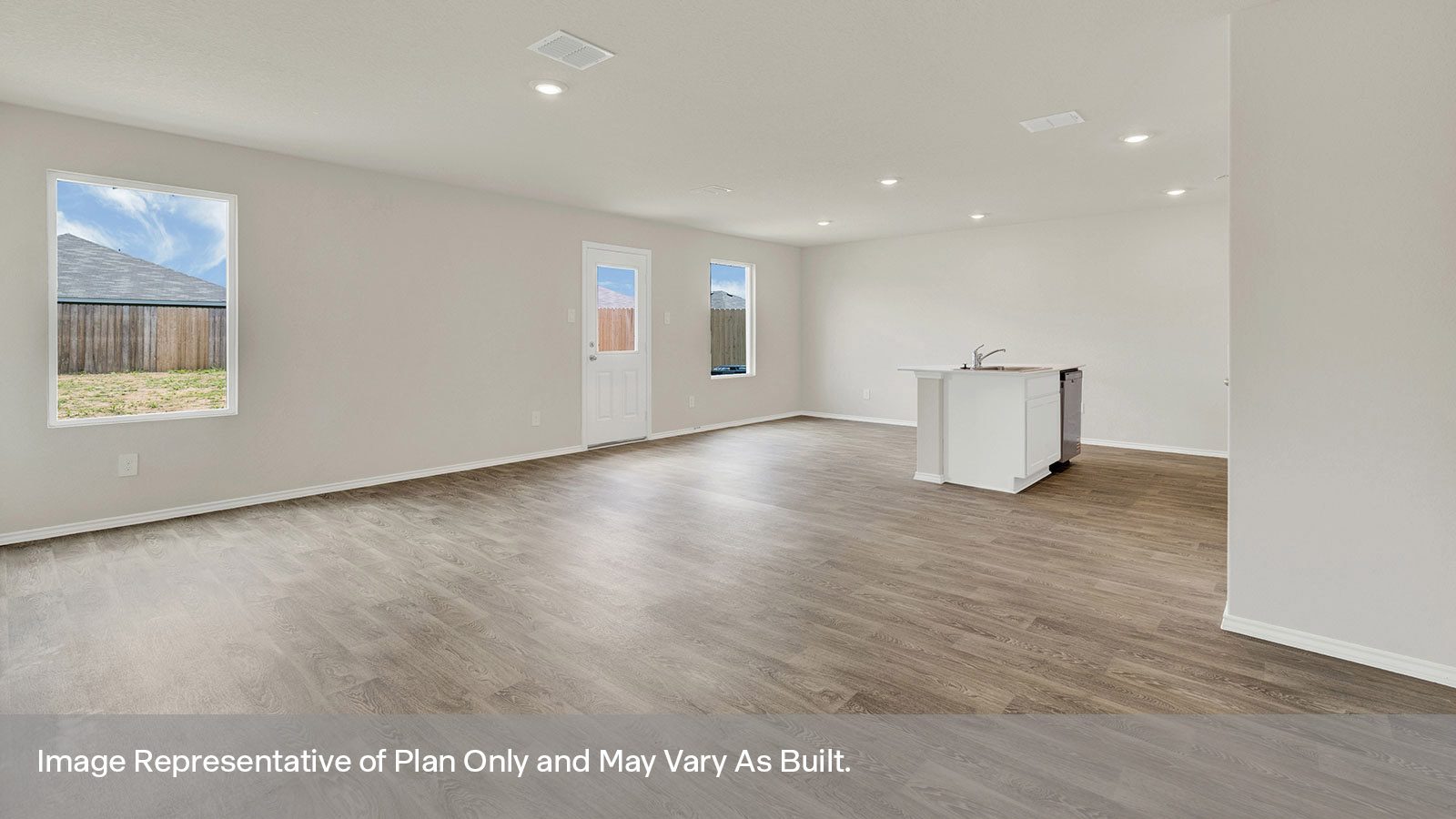 Living room, dining room and kitchen with vinyl flooring, two windows and a half-lite exterior door.
