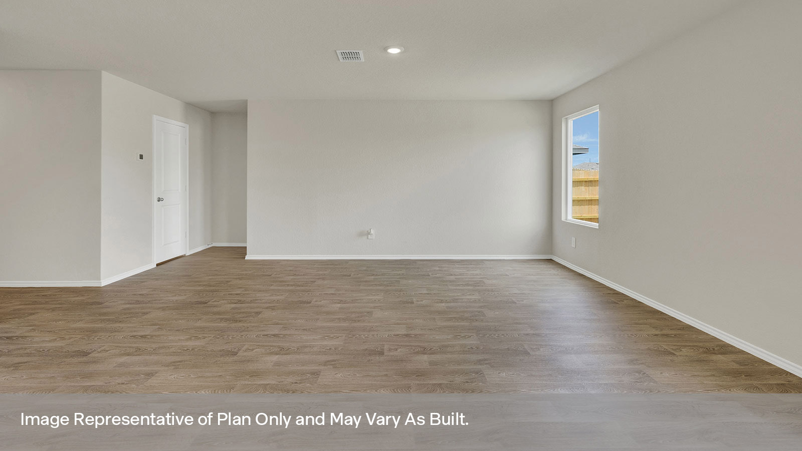 Living room with vinyl flooring and entry way to primary bedroom.