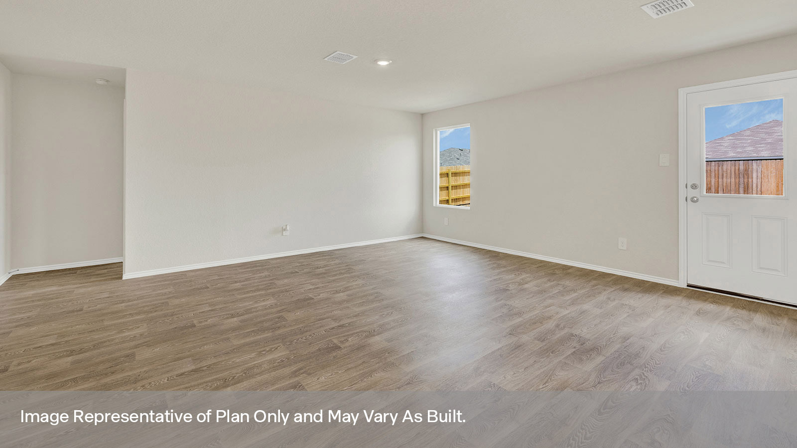 Living room with vinyl flooring and windows.