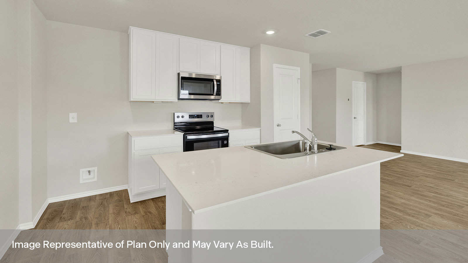 Kitchen with quartz countertops and stainless steel appliances.