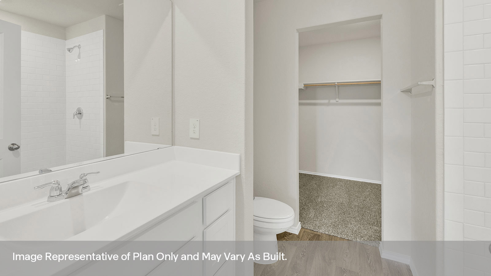 Main bathroom with vanity, toilet, and closet.