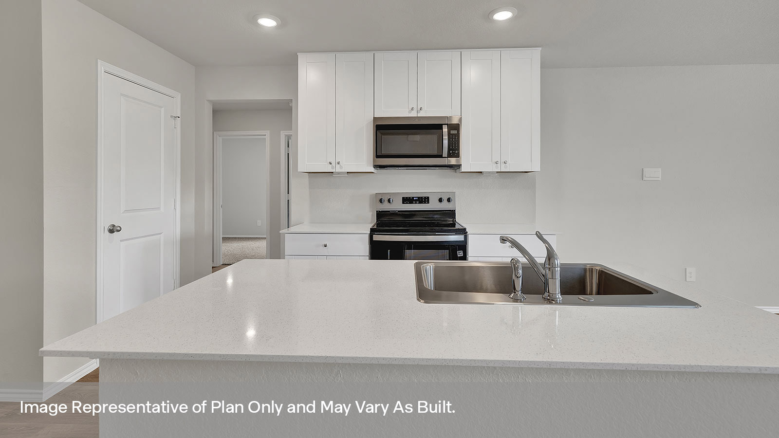Kitchen with kitchen island and quartz countertops.