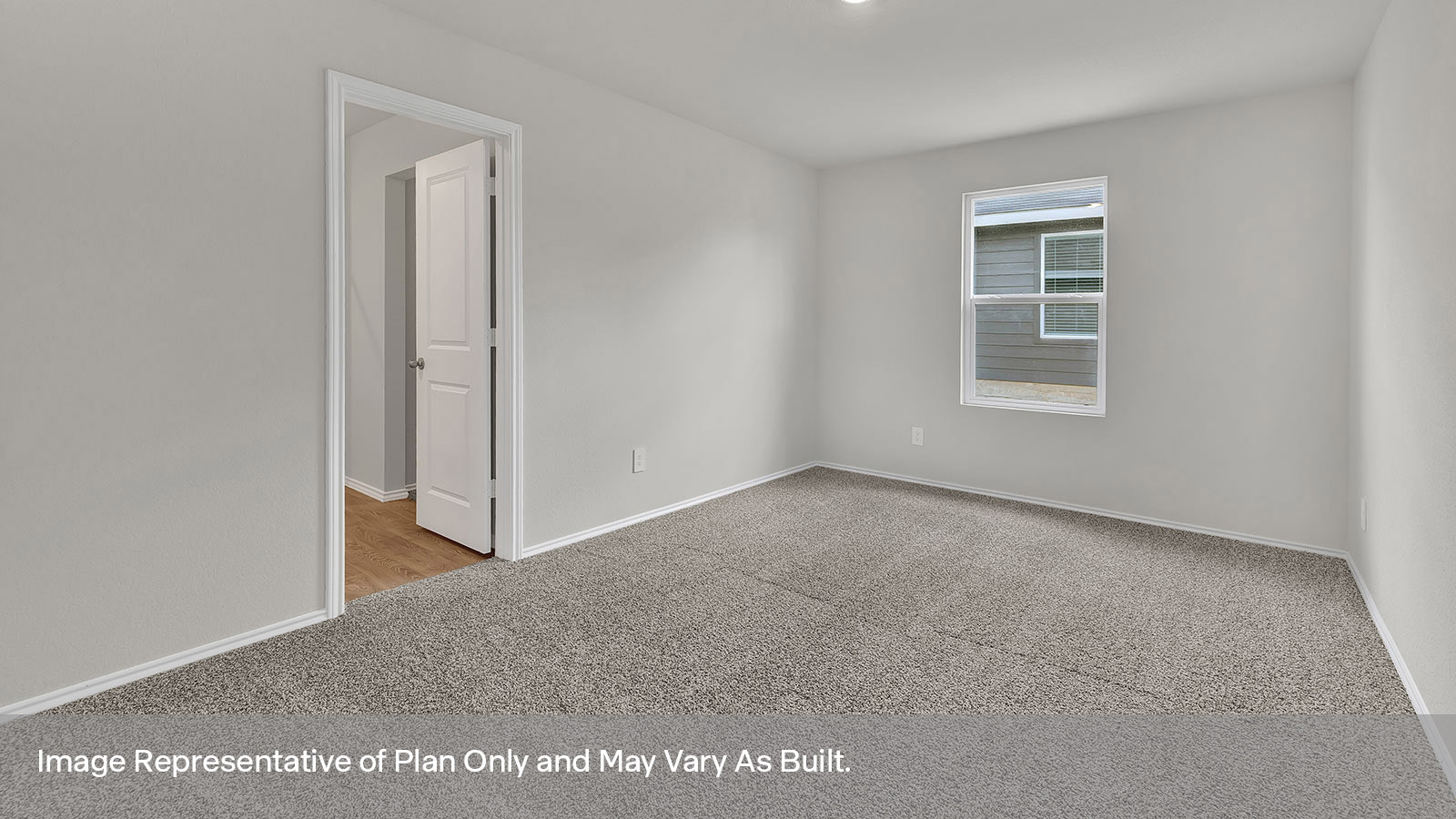 Main bedroom with carpeting and doorway.