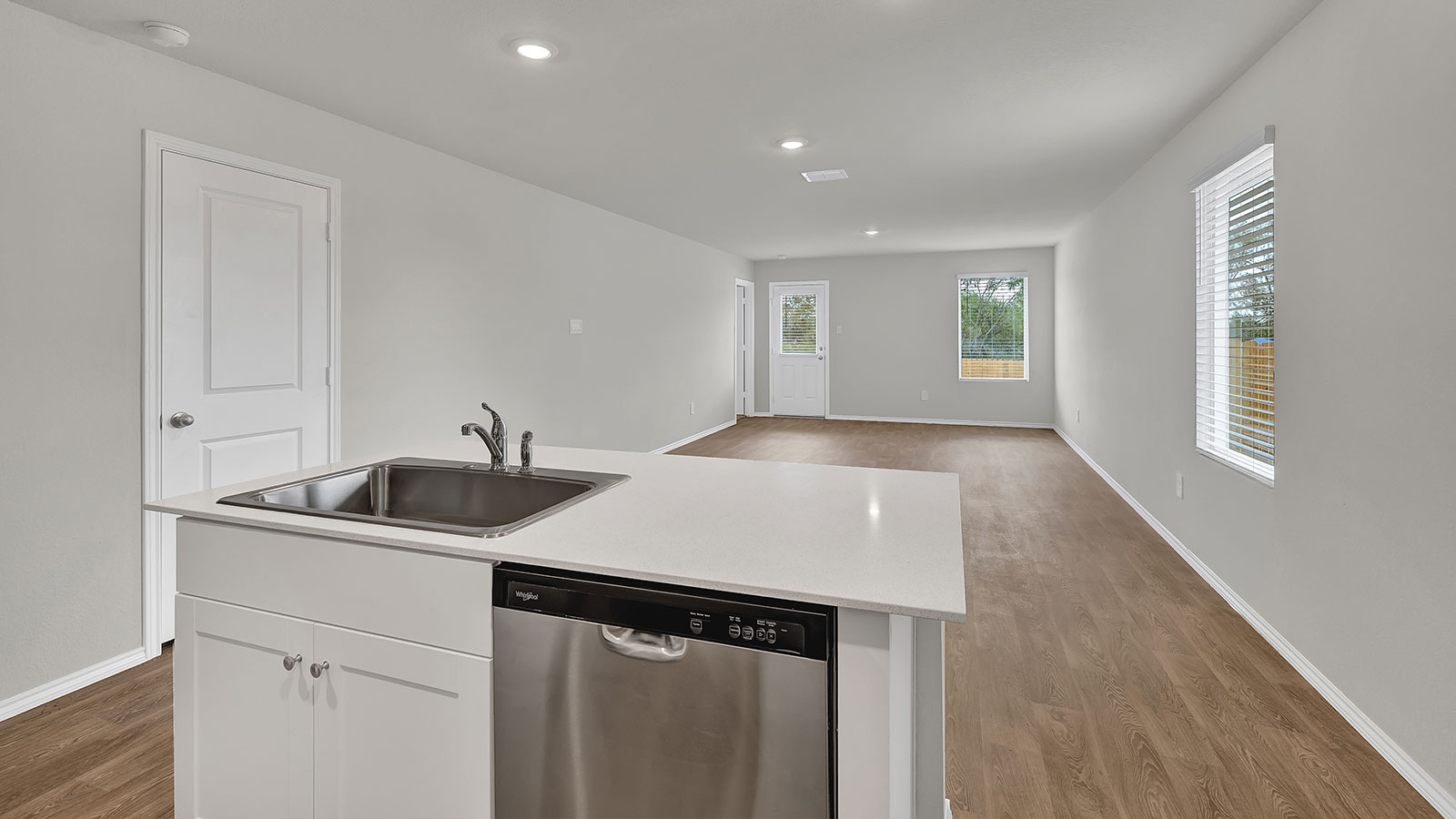 Kitchen with quartz countertops and stainless steel appliances.