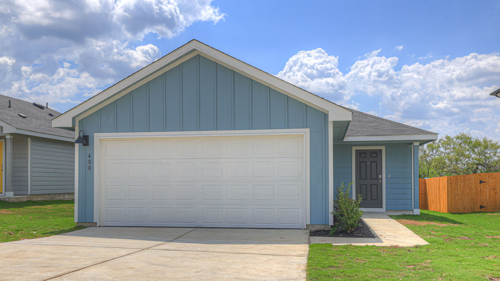 Single-story farmhouse with 2 car garage.