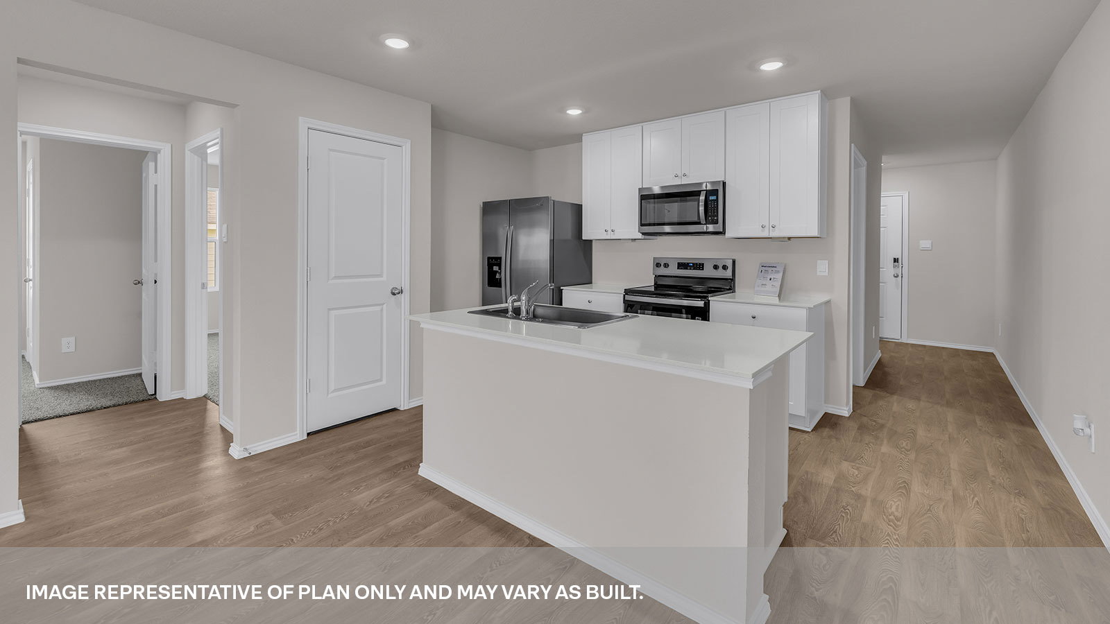 Entry hallway leading to the kitchen with kitchen island.