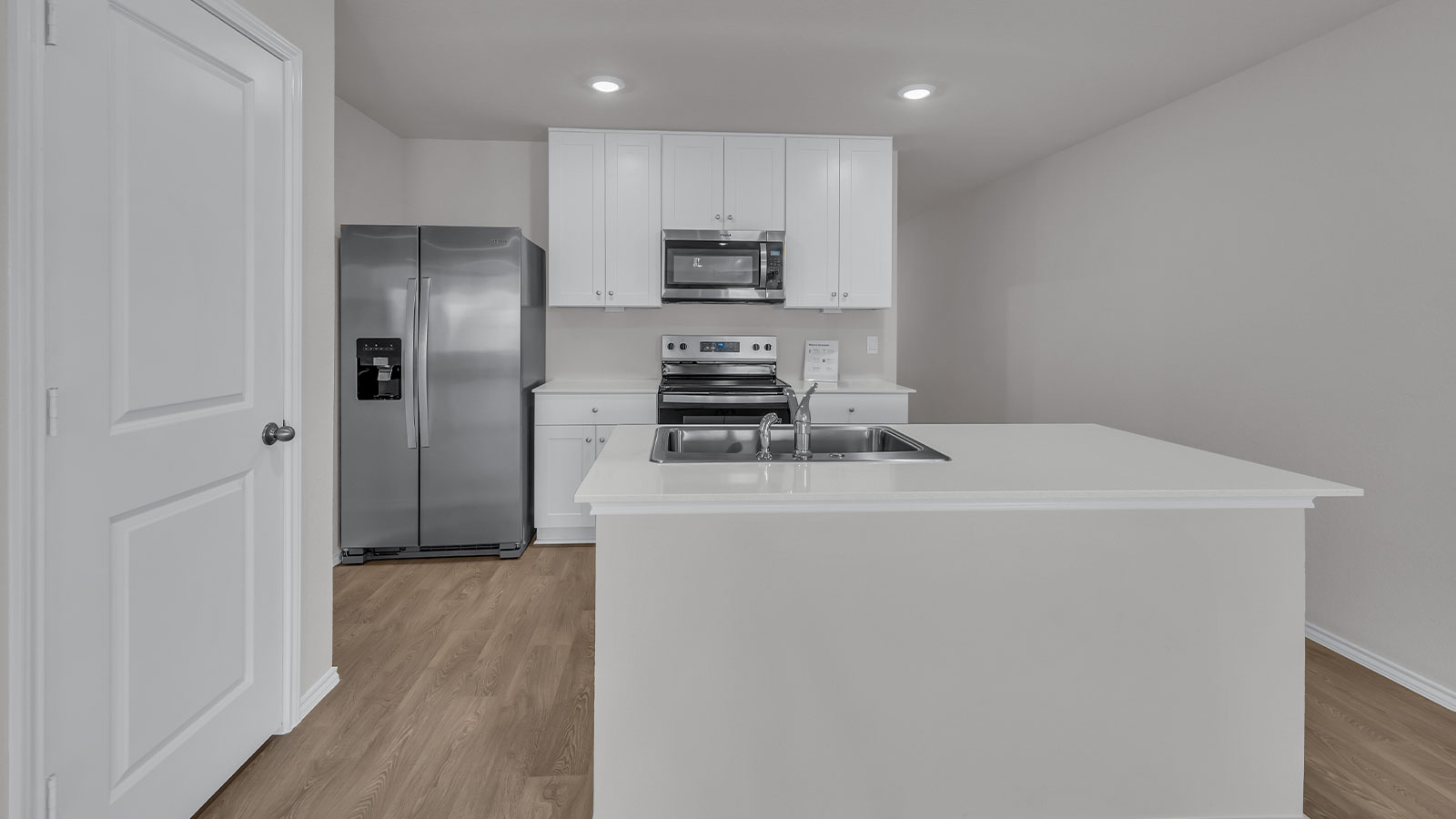 Kitchen with kitchen island and white cabinets.
