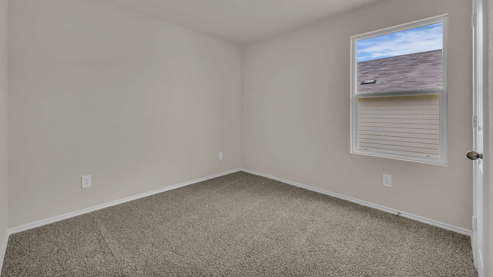 Secondary bedroom with carpeting and one window.