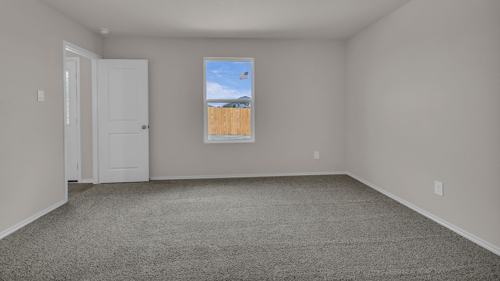 Main bedroom with carpeting and one window.