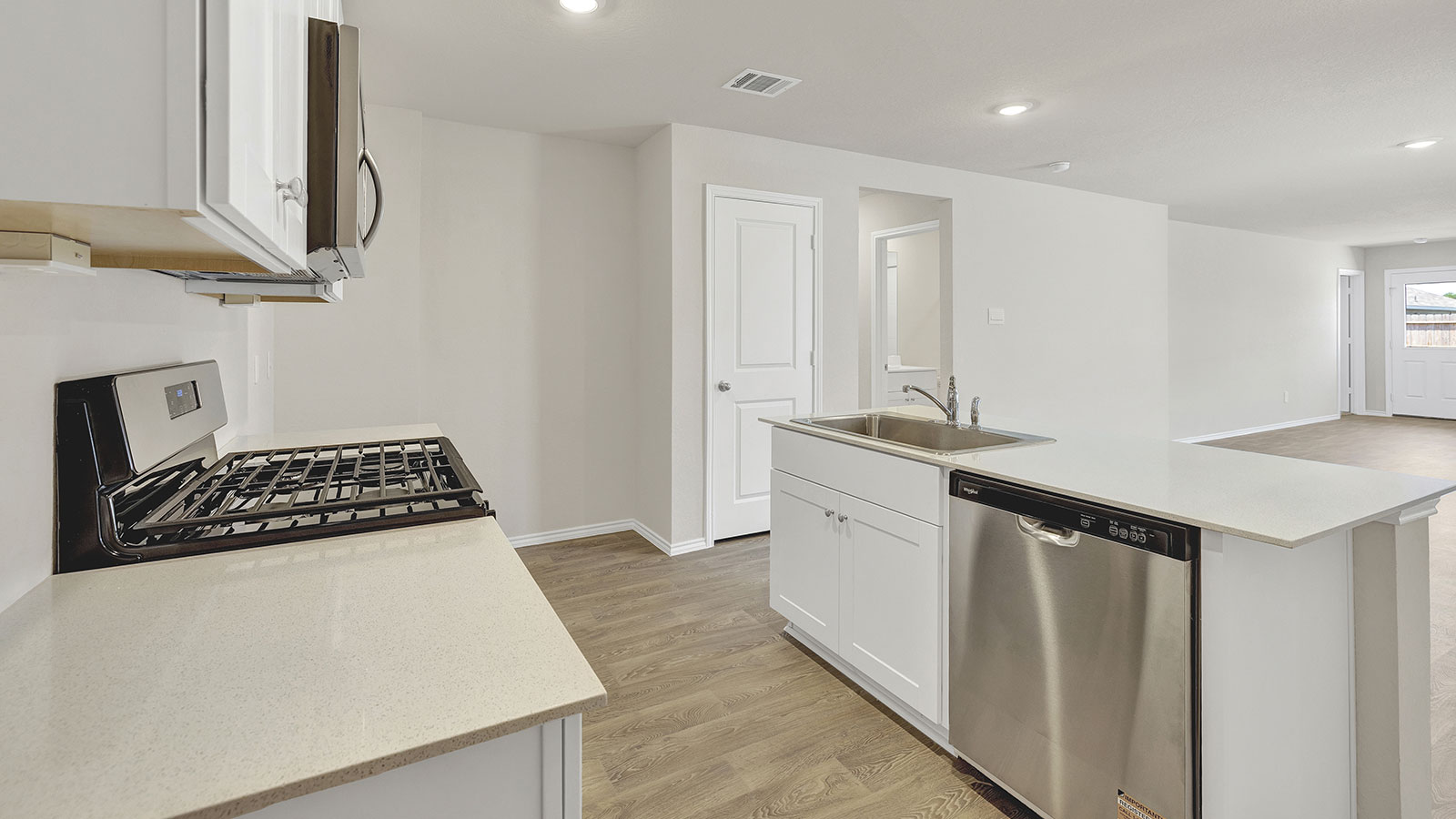 Kitchen with kitchen island and white cabinets.