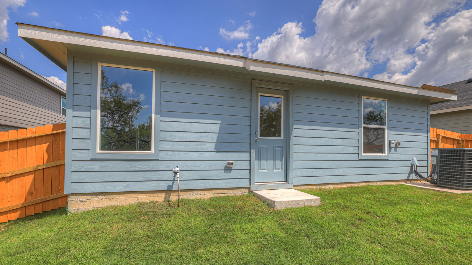 Backyard with sod and privacy fence.