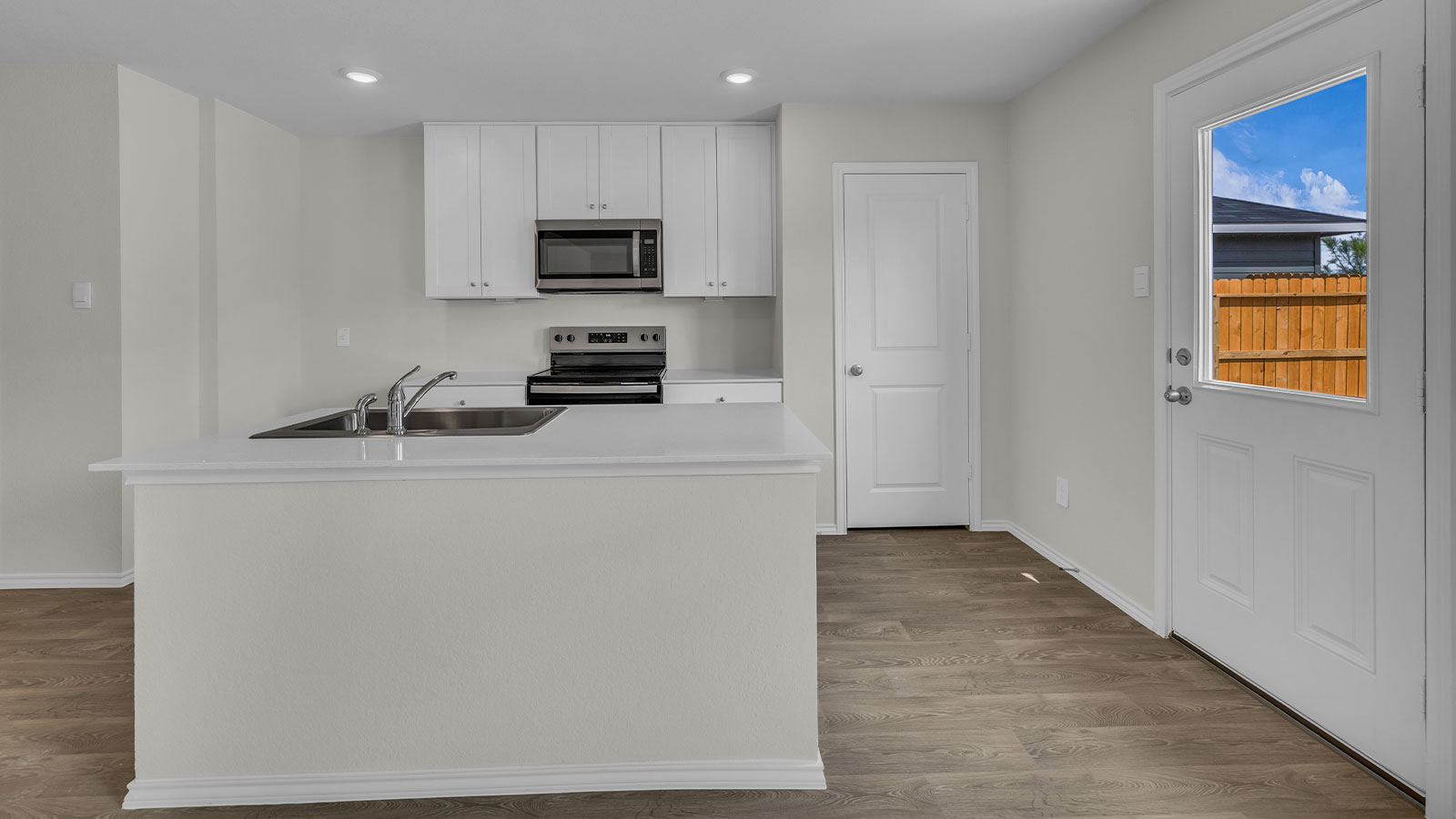 Kitchen with white cabinets and stainless steel appliances.