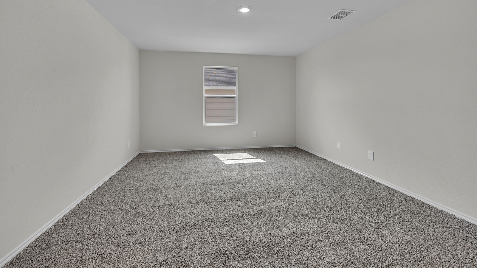 Main bedroom with carpeting and one window.