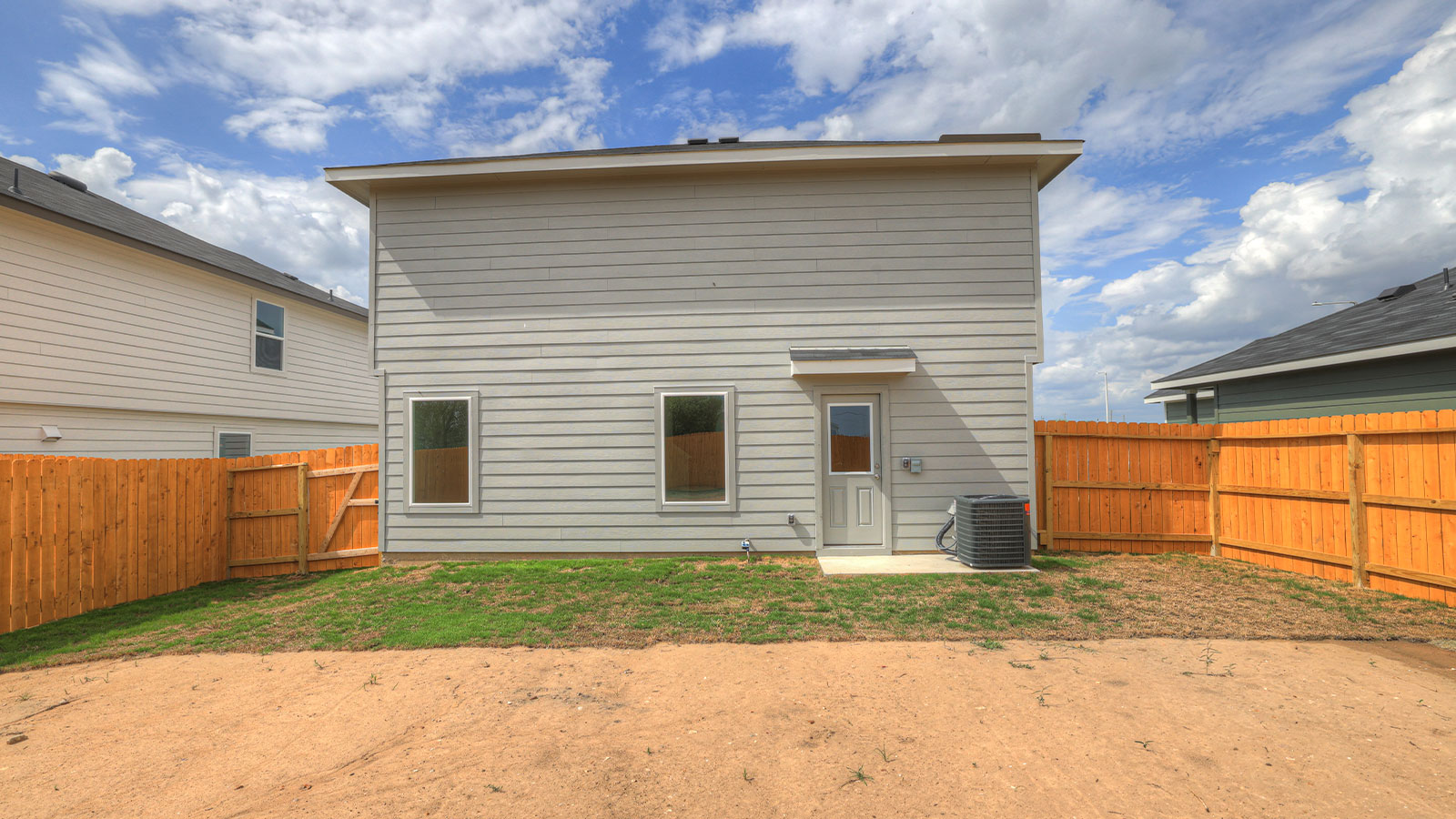 Backyard with sod and privacy fence.