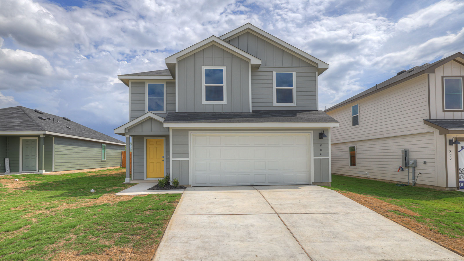 Two-story farmhouse exterior photo with 2 car garage.