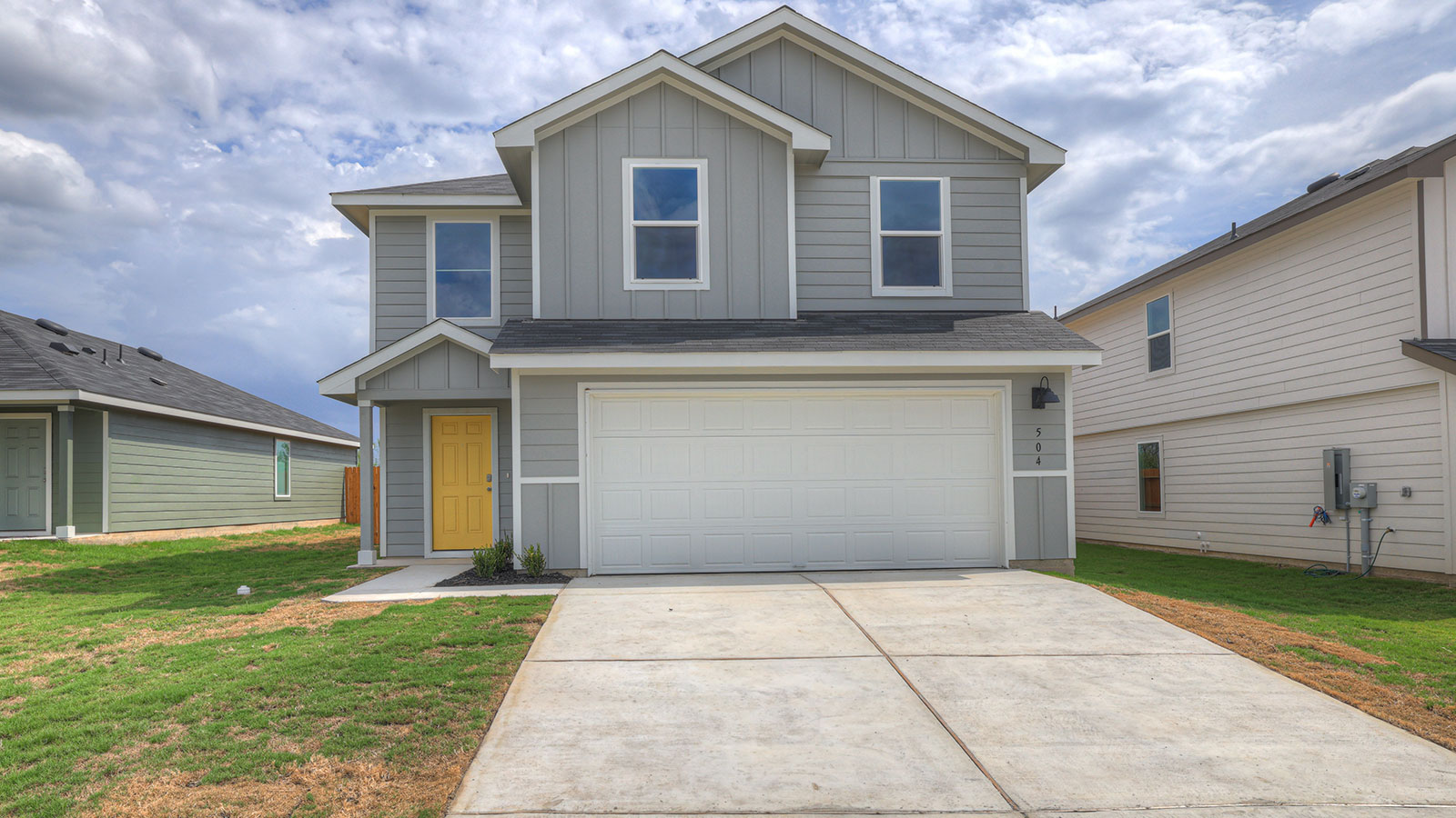 Two-story farmhouse exterior photo with 2 car garage.