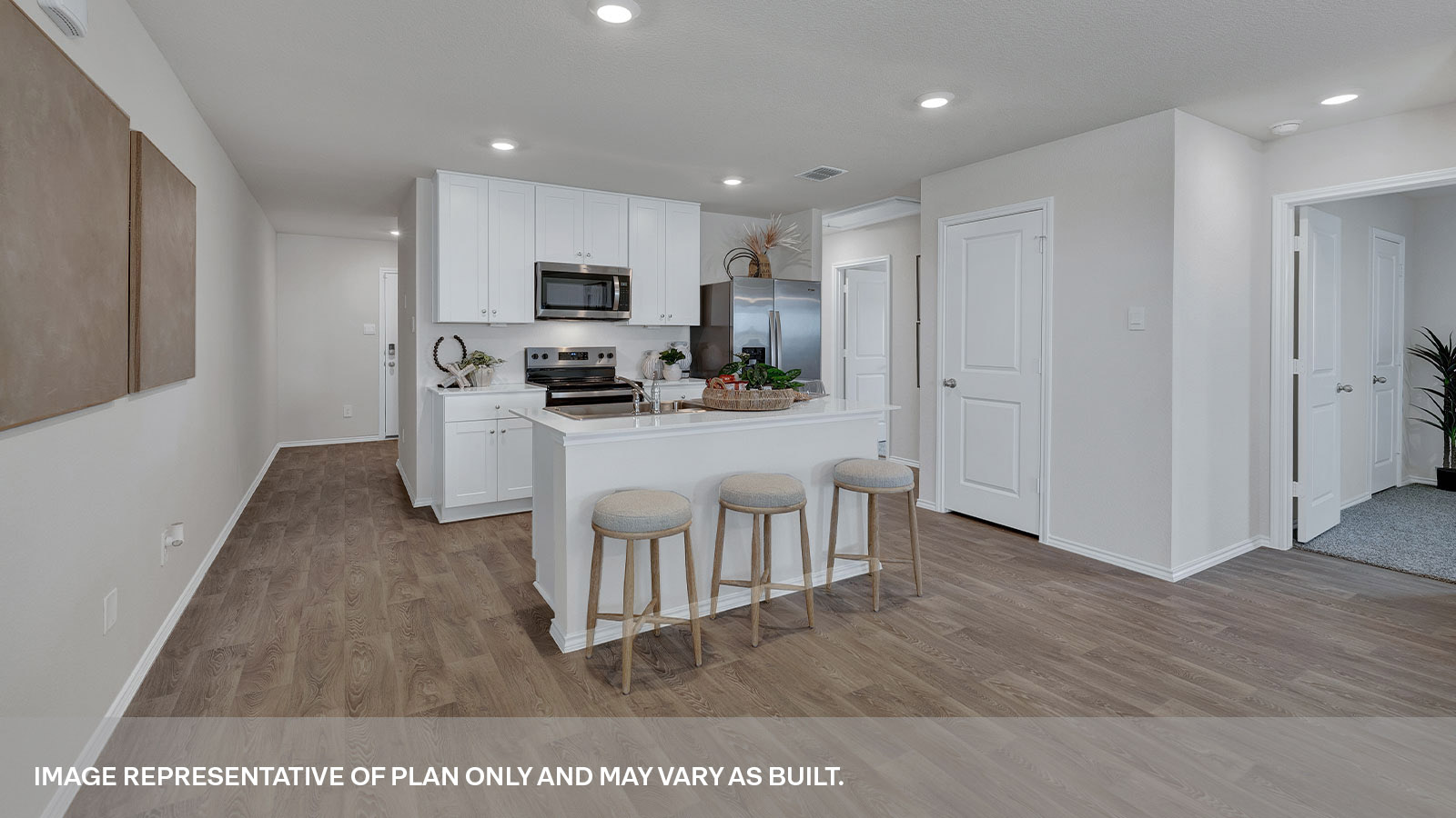 Kitchen with kitchen island and entry hallway.