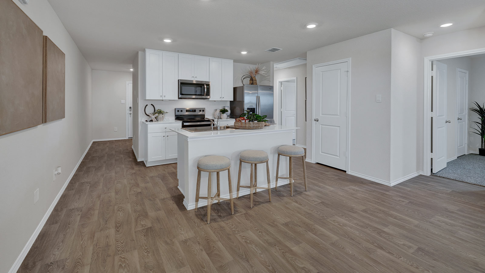 Kitchen with kitchen island and white cabinets.