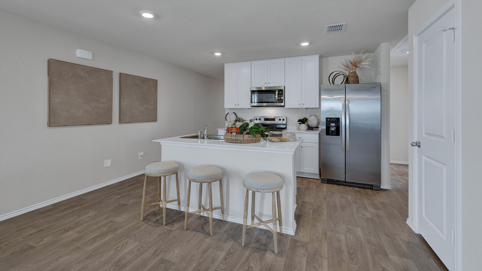 Kitchen with kitchen island and white cabinets.
