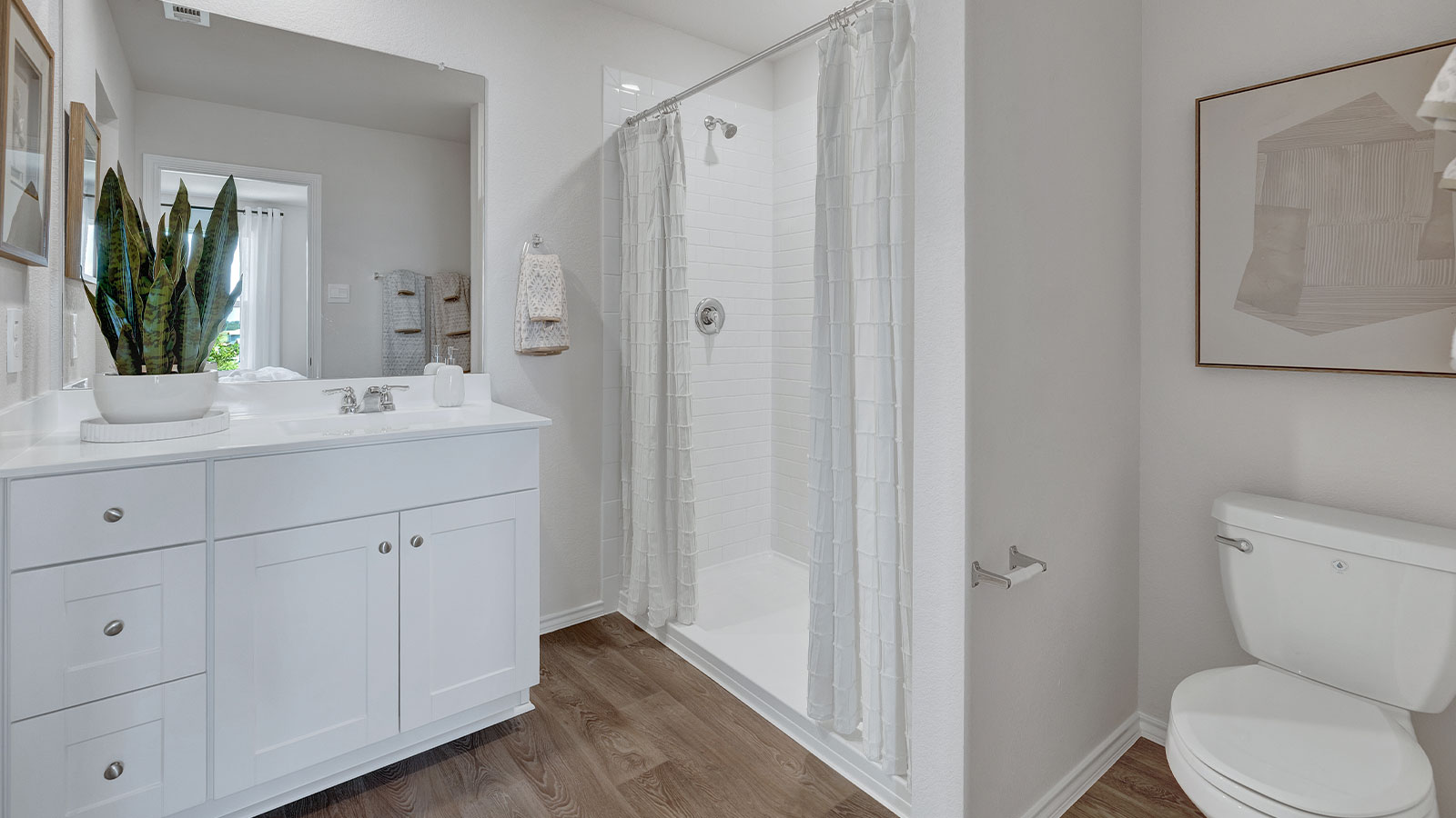 Main bathroom with shower, toilet, and sink.