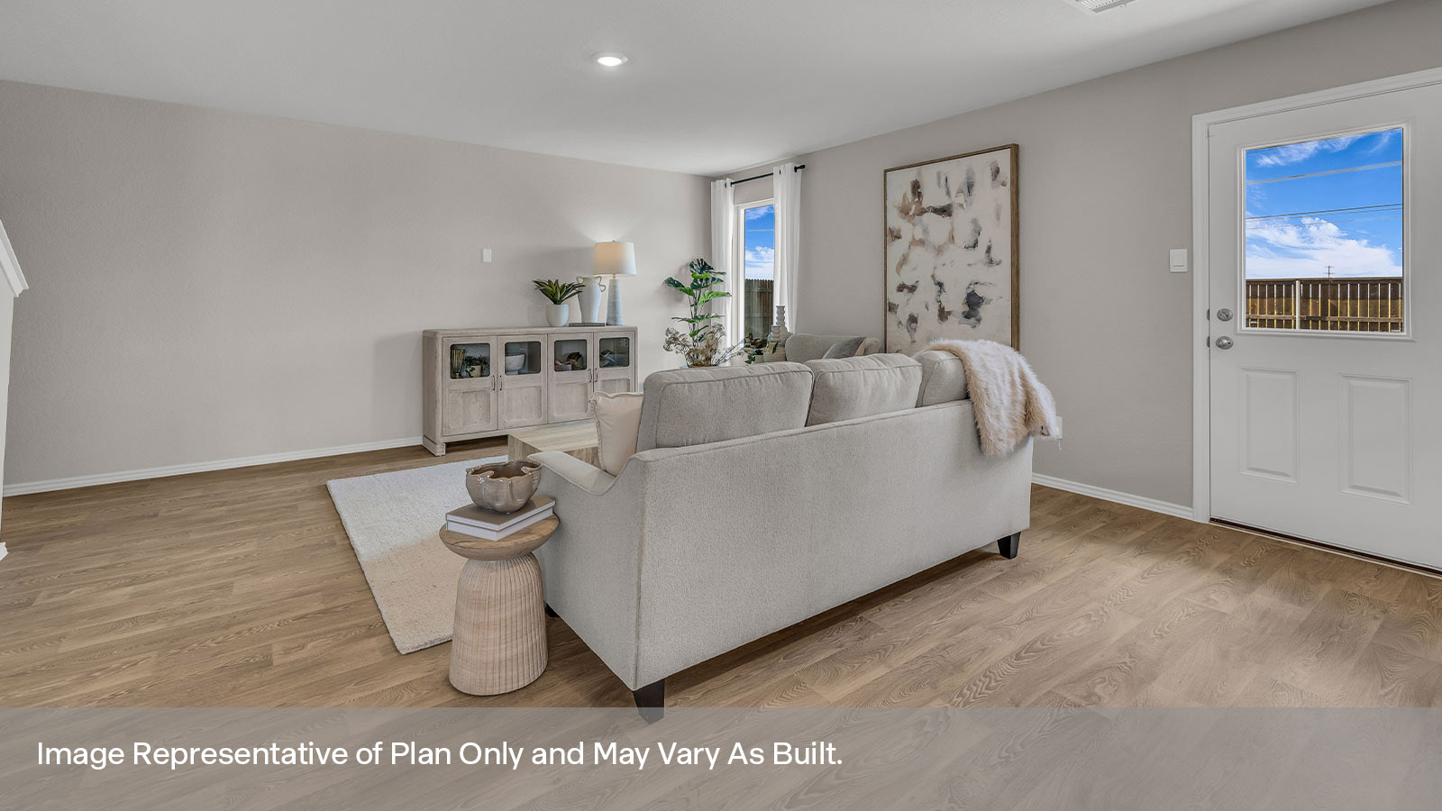 Living room with vinyl flooring, one window, and a half lite exterior door.