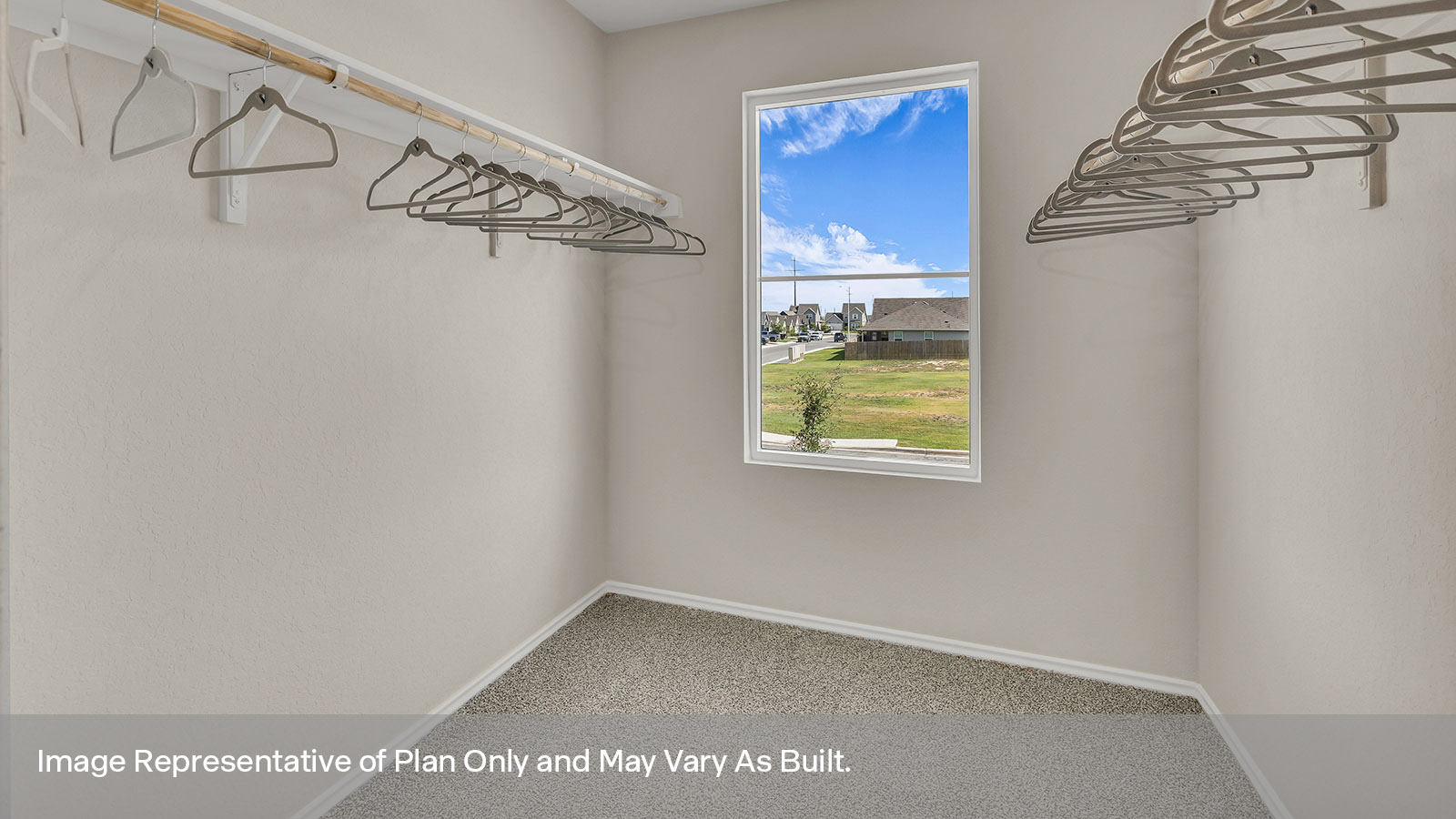 Main bedroom closet with carpeting and wooden shelving.