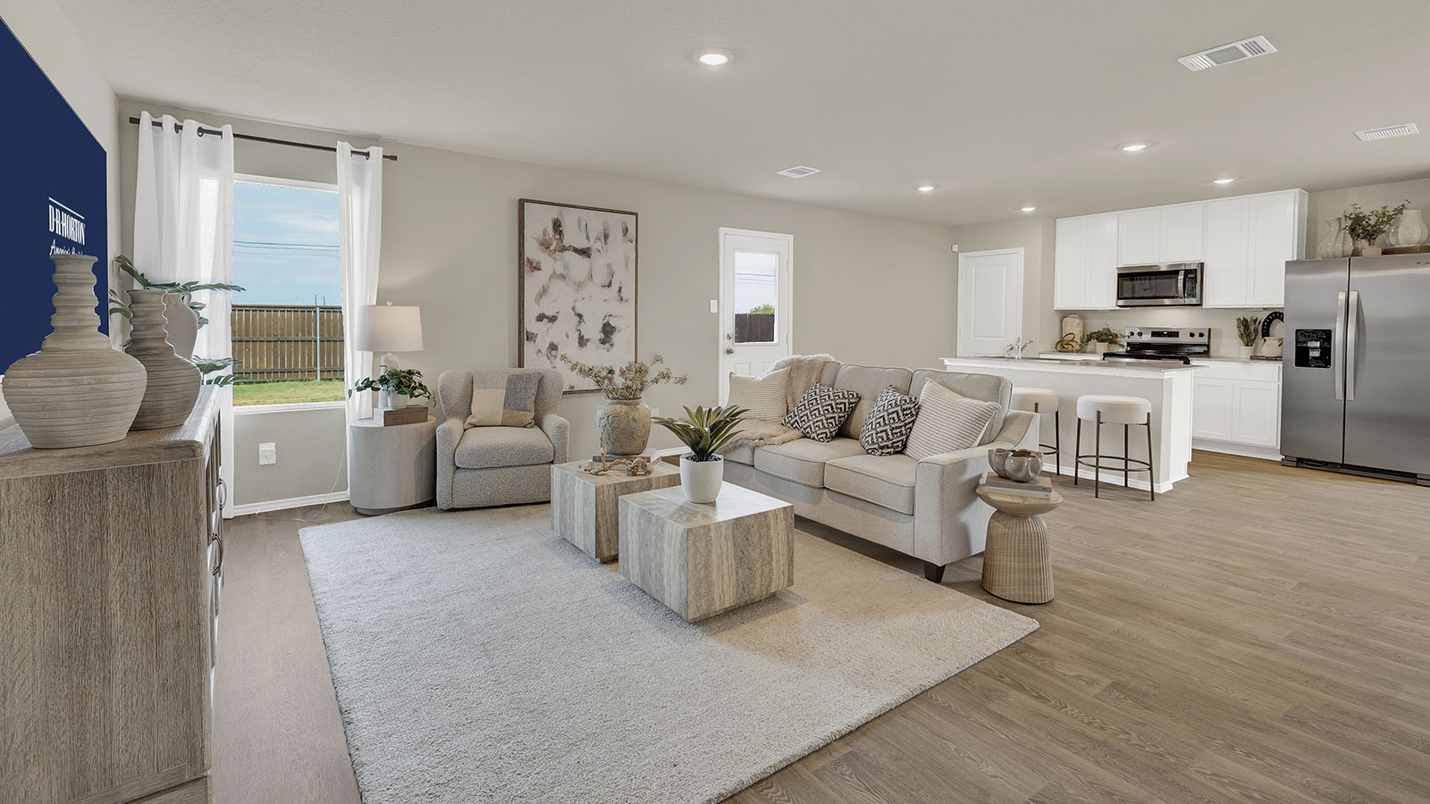 Living room with vinyl flooring with one window and a half lite exterior door.