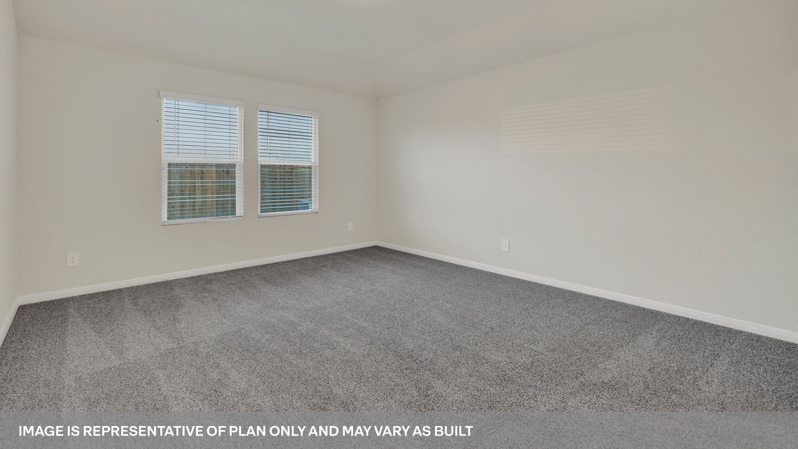bedroom with beige carpet, beige walls and a window