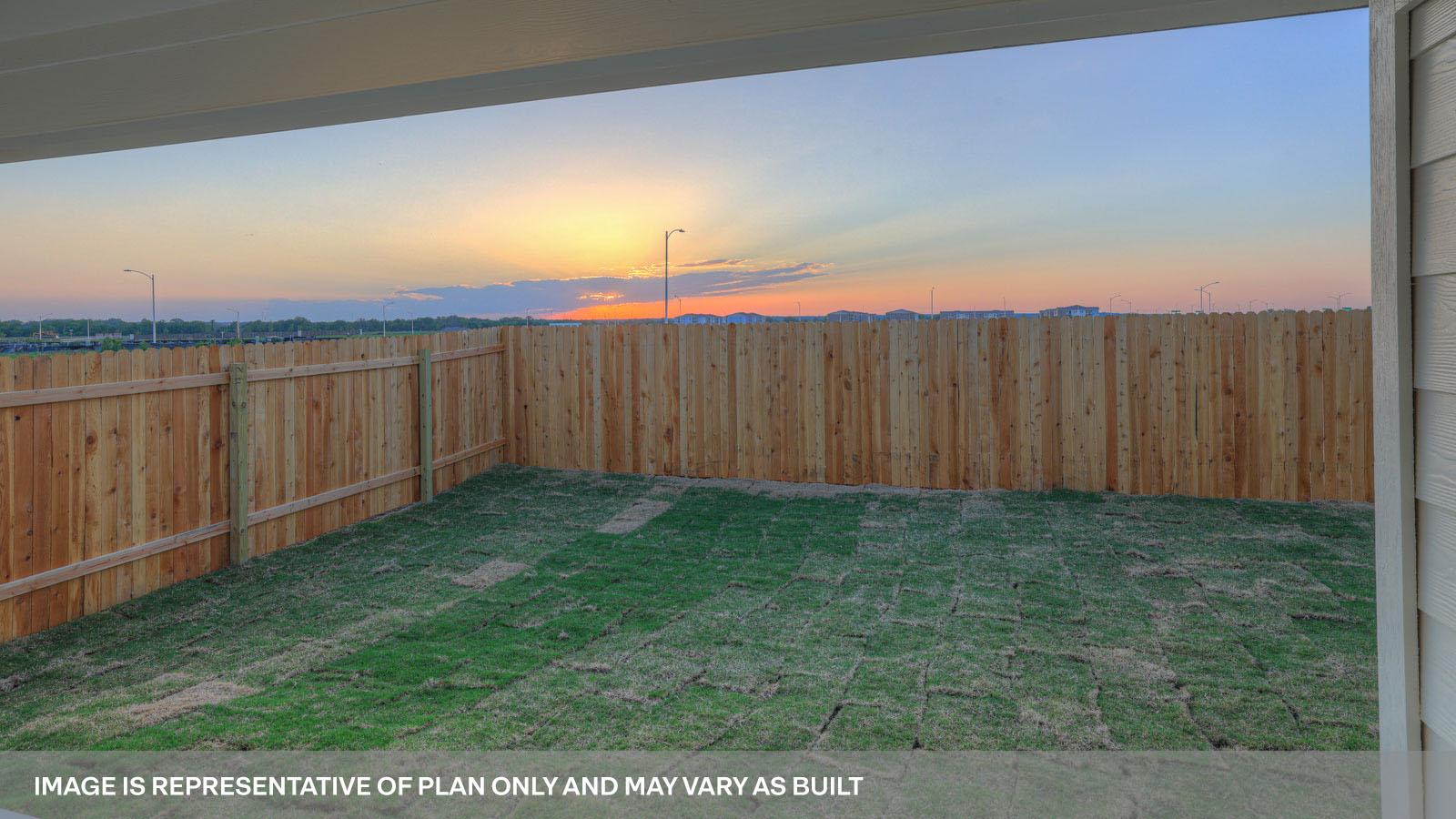 rear exterior of home featuring a spacious fenced in backyard