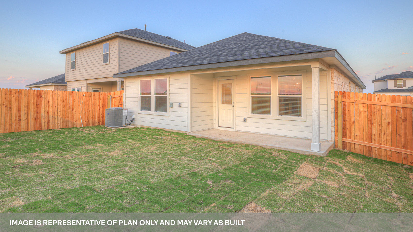 rear exterior of home featuring a spacious fenced in backyard
