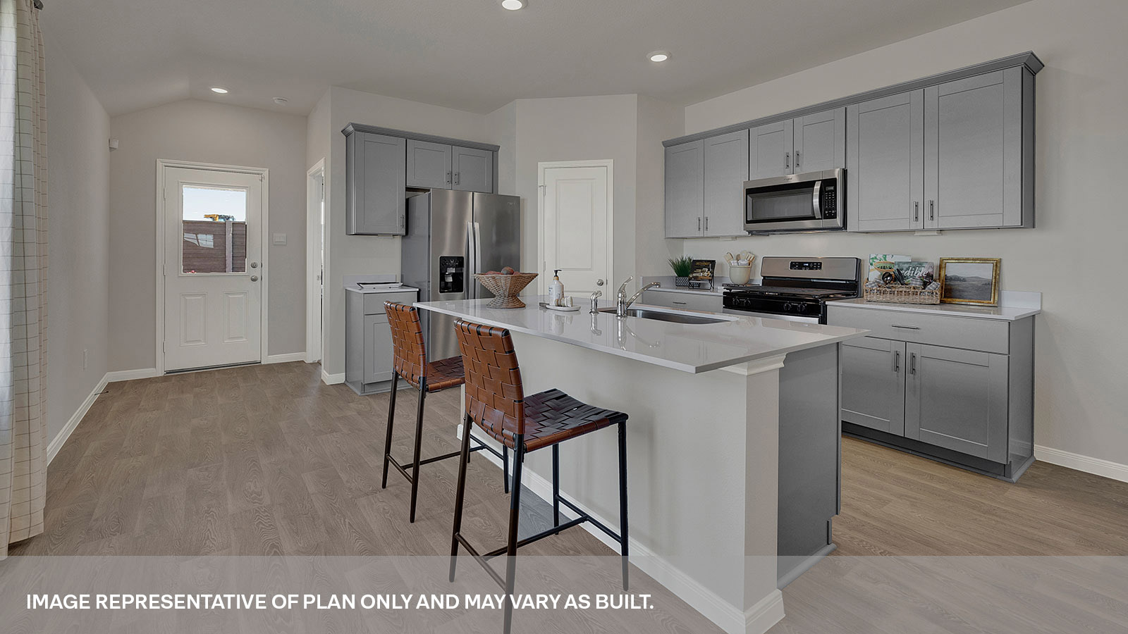 Kitchen island with quartz countertops and kitchen sink.