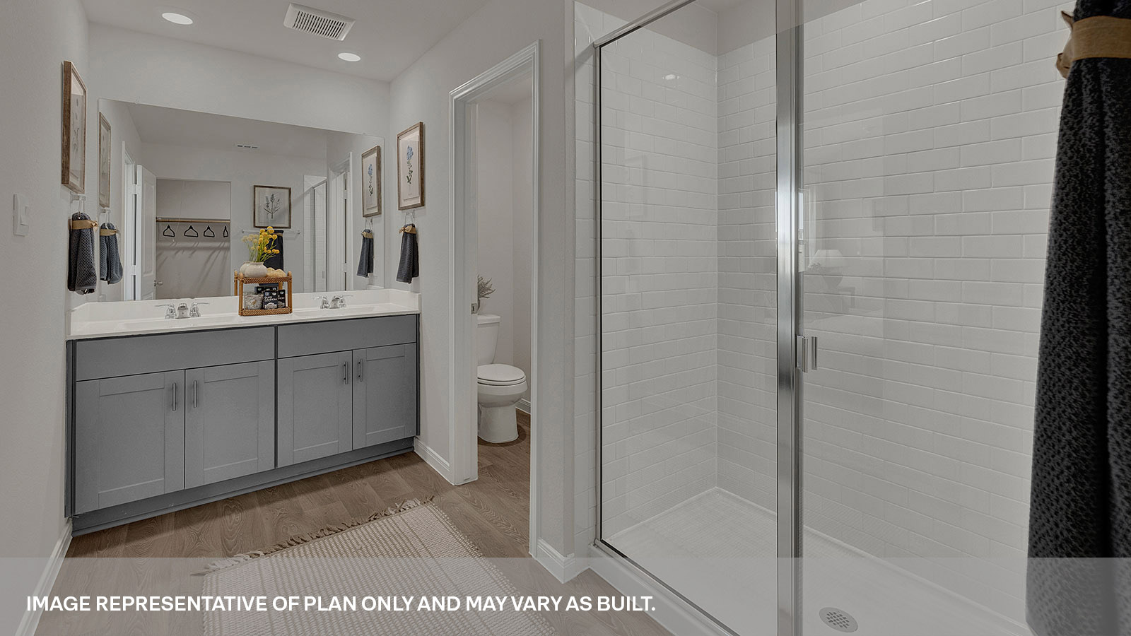 Main bathroom with double sink vanity and shower.