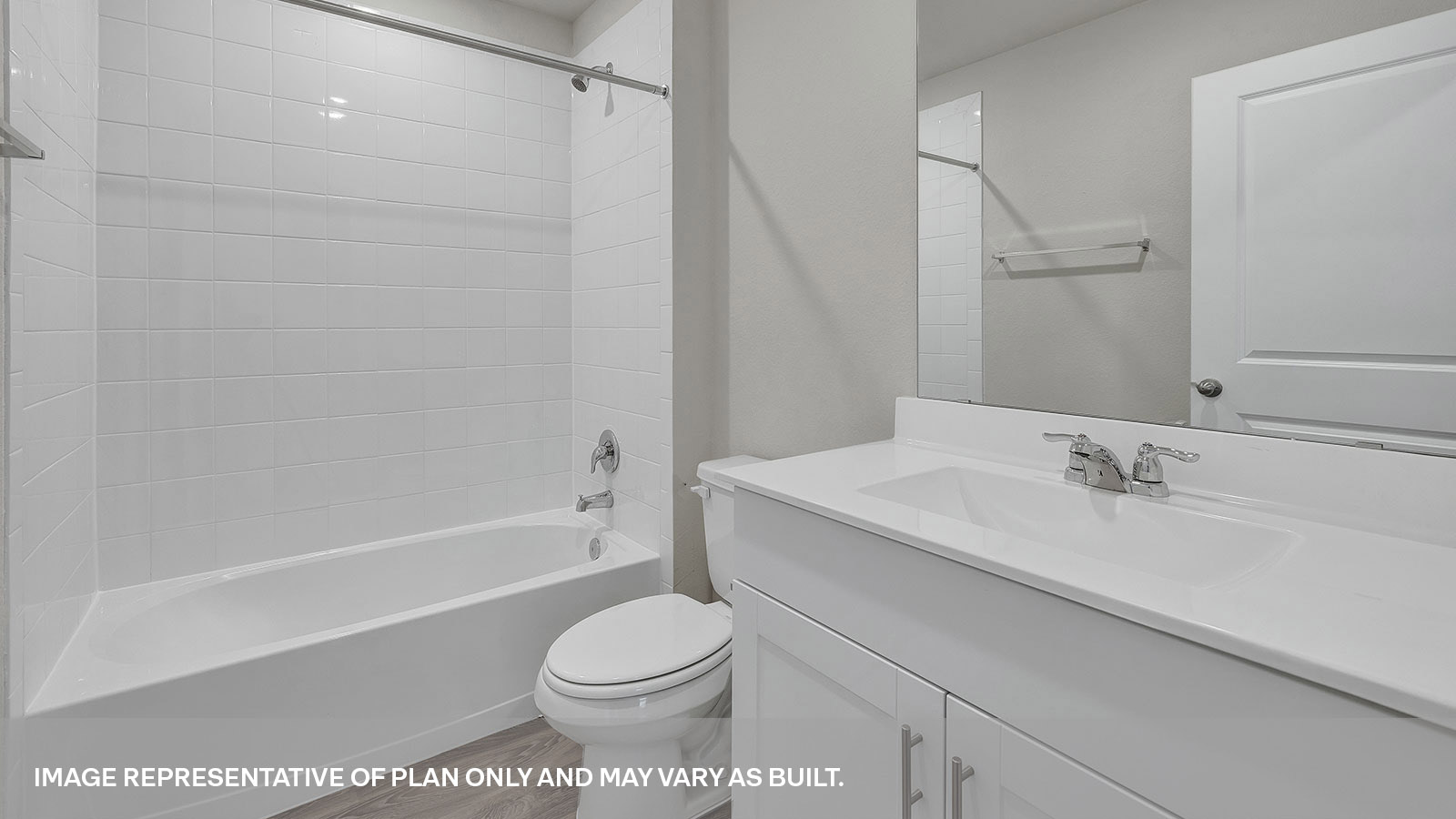 Hall bathroom with single sink vanity, toilet, and tub with tile surround.