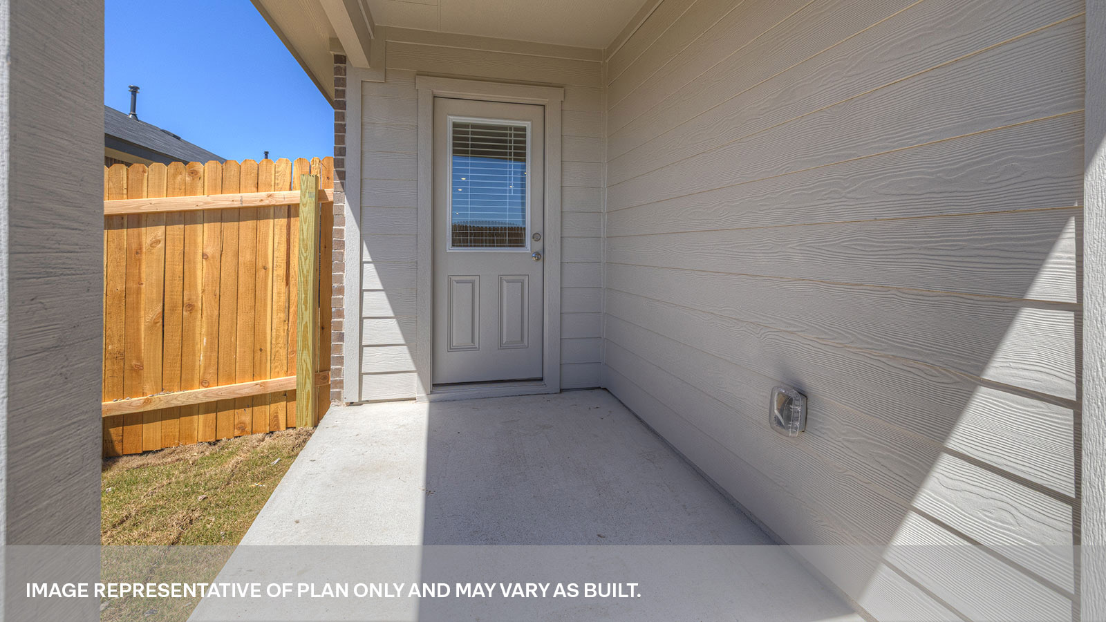 Covered patio with half lite exterior door.