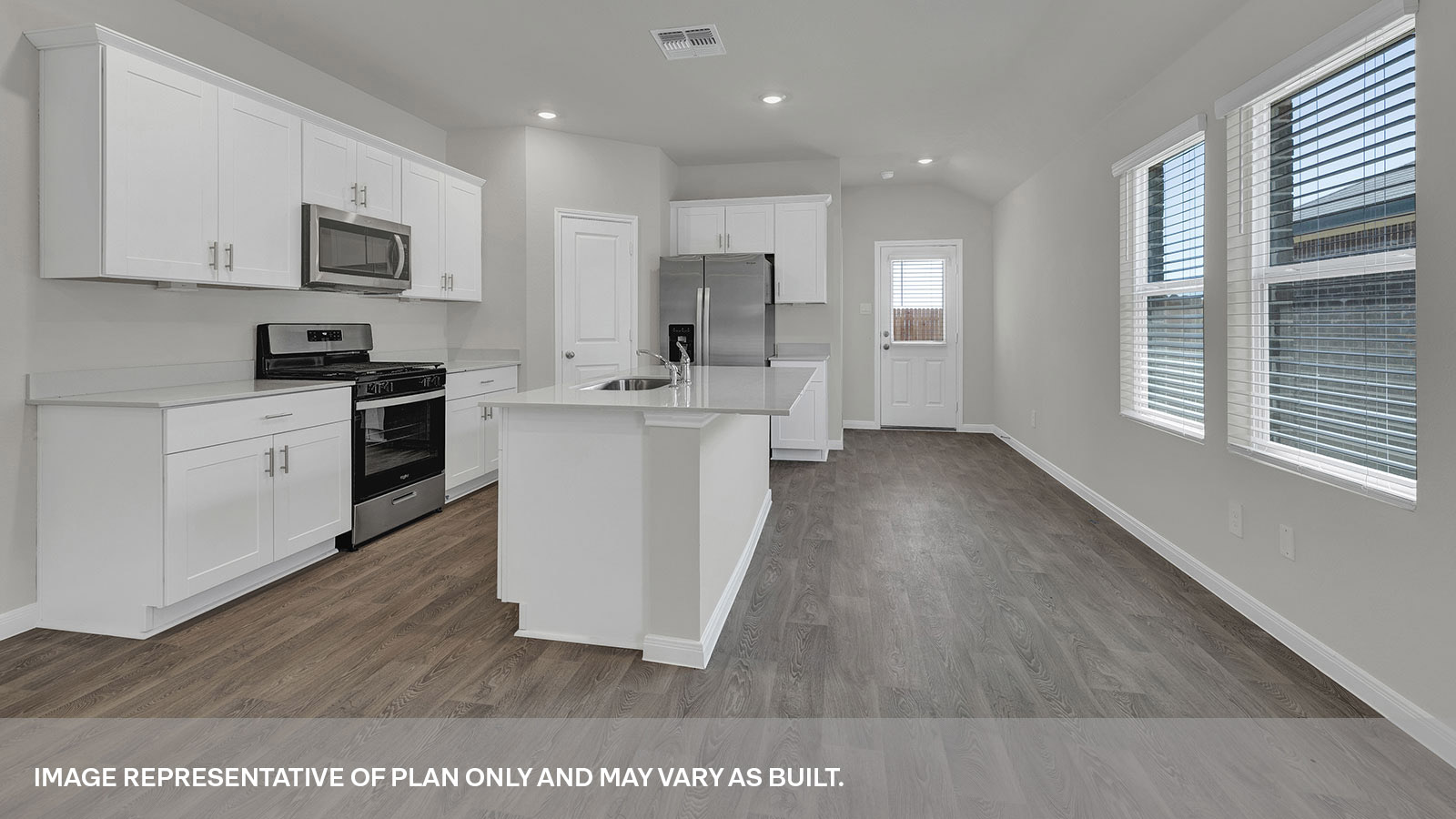 Kitchen with kitchen island and white cabinets.