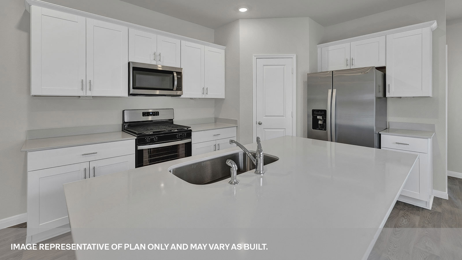 Kitchen island with quartz countertops and kitchen sink.