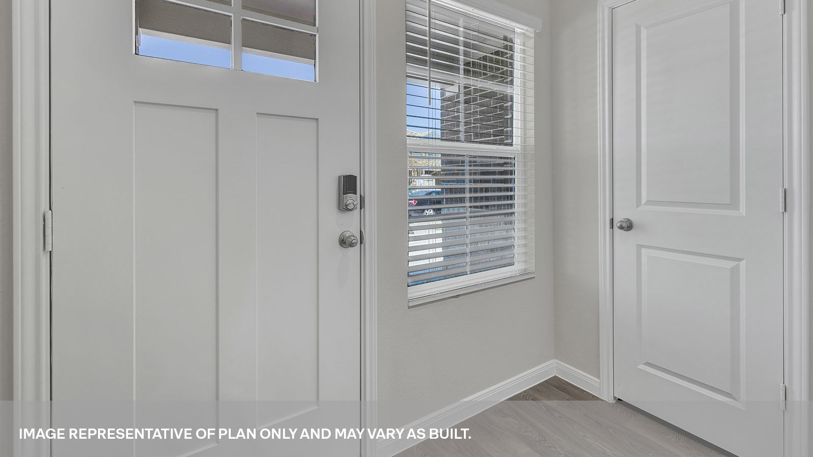 Entryway with vinyl flooring, one window and front door.